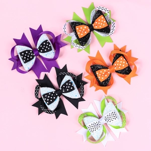 Set of 5 multilayered Halloween bow hair clips with glitter and polka dots on pink background