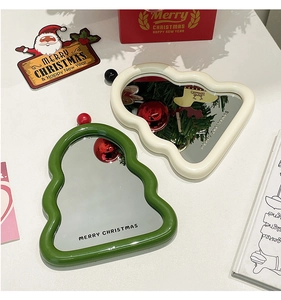 Macro view of Christmas tree shaped vanity mirror with wavy cream and green borders