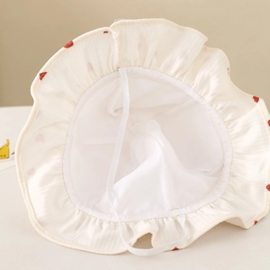 Detail view of baby sun hat with soft white cotton lining and elastic windproof strap