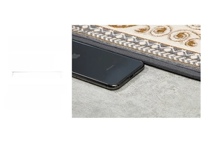 Detail of 8mm ultra-thin door mat showing thickness comparison with a phone