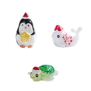 Miniature resin Christmas sea animals including penguin and seal with red festive hats
