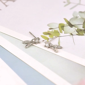 Macro shot of S925 silver leaf earrings with zircon stone and official hallmark