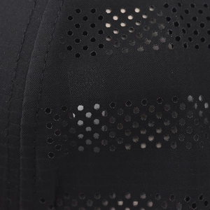 Macro detail of laser-perforated breathable fabric with fine double-stitch sewing