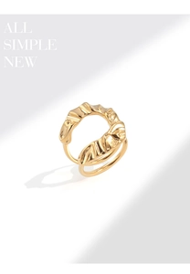 Detailed close-up of a double-layered gold U-shaped pleated ring with textured ripple finish