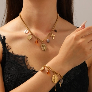 Detail of 18K gold-plated necklace set with oval Virgin Mary and cross charms