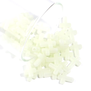 Close-up of luminous green cross-shaped beads for DIY jewelry and handmade crafts