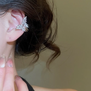 Detailed view of butterfly ear cuff with marquise zircon stones in gold finish
