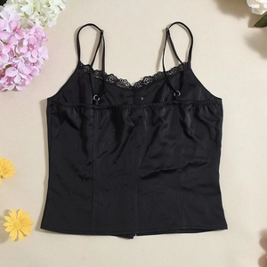 Detail of black silk camisole featuring delicate lace trim and adjustable shoulder straps