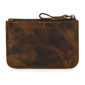 Detailed close-up of dark brown genuine leather coin purse with textured finish and zipper
