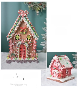Detailed view of gingerbread house Christmas ornaments with festive icing and candy accents