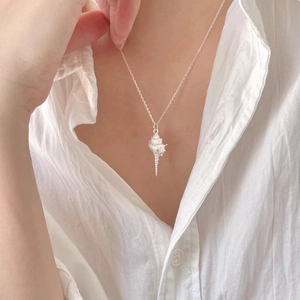 Elegant 925 sterling silver conch pendant necklace worn on neck for a minimalist ocean style
