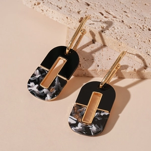 Dark style marble acrylic oval geometric earrings with gold accents in 45-degree view
