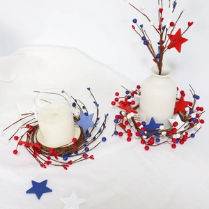 Detail of red white and blue patriotic berry wreath around a glass candle holder