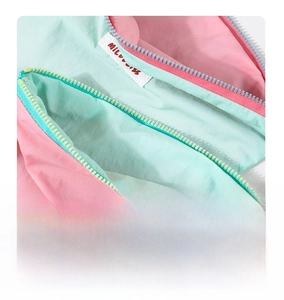 Detail of pink and mint green nylon storage bag with contrasting zipper and fabric texture