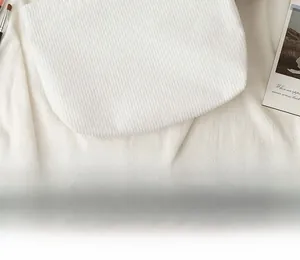 Close-up of white corduroy fabric with vertical striped texture on portable cosmetic bag