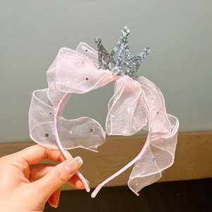 Detail of pink mesh headband with silver crown and star sequins for girls