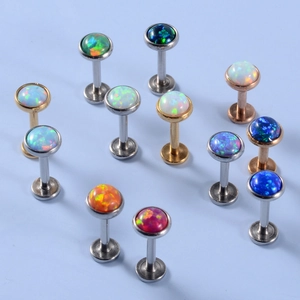 Macro shot of colorful opal stones on stainless steel labret studs in assorted metal finishes