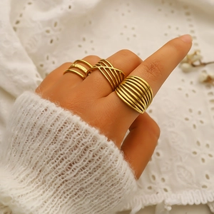 Three-piece set of 18K gold plated minimalist geometric rings worn by a model