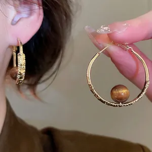 French vintage gold hoop earrings with textured finish and tiger eye stone beads