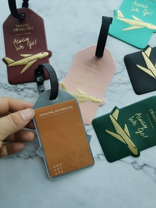 Detail of colorful airplane-shaped faux leather luggage tags with clear ID card slots