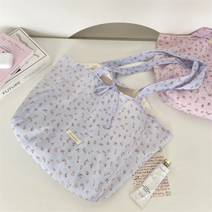 Detail of floral chiffon tote bag showing fabric texture and drawstring closure