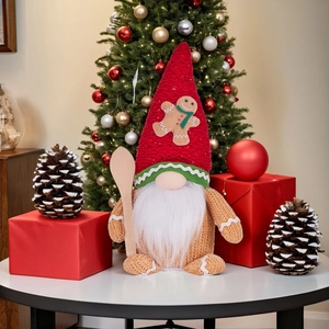 Christmas gnome doll with knitted red hat and wooden spoon in a festive holiday setting