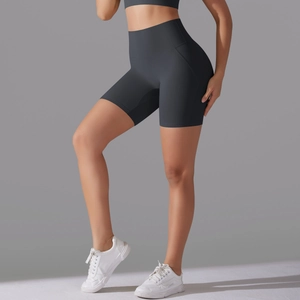 Detail view of high-waist grey yoga shorts showing seamless elastic fabric and slim fit