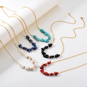 Detail of five colorful natural stone bead necklaces with elegant gold chains
