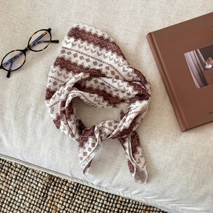 Close-up of geometric pattern cotton linen neck scarf styled with vintage accessories