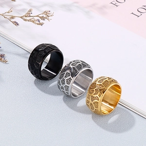 Three men's vintage wide rings in black, silver, and gold with honeycomb texture