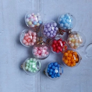 Macro shot of 16mm colorful glass globe charms with vibrant bead fillings for DIY jewelry
