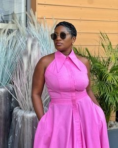 Detail of pink halter neck dress featuring pointed collar and high waist design