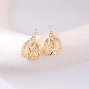 Fashionable gold plated double hoop earrings with cubic zirconia stones in macro view