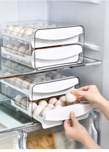 Close-up of a double-layer clear plastic egg drawer box inside a refrigerator