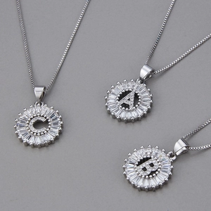 Detailed view of three silver necklaces with A, B, and C zircon-studded initial pendants