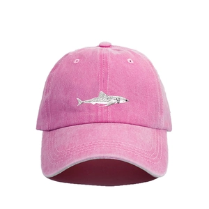 Close-up of pink washed cotton baseball cap featuring silver shark embroidery detail