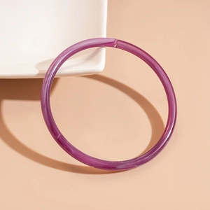 Detail of purple acrylic bangle showing natural white marble texture and translucent resin