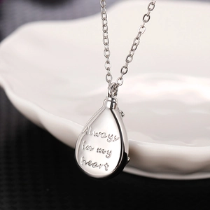 Dettaglio della collana a goccia d'argento con incisione Always in My Heart sul metallo