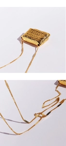 Detail showing the intricate gold woven texture and luxury finish of the handbag necklace