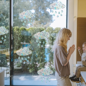 Rainbow prism cloud and raindrop window film showing a cozy family kitchen scene