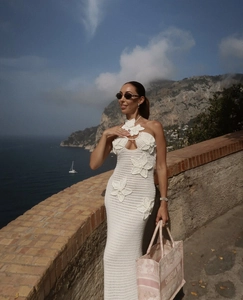 Detail of white crochet floral dress showing hollow-out texture and 3D woven flowers