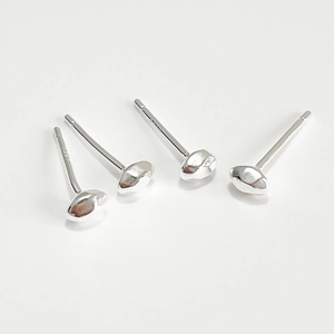 Macro shot of 925 sterling silver stud earrings with smooth pebble design on white base