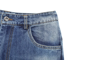 Detail of blue denim jeans waist with contrast stitching and metal button texture