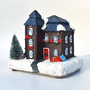 Luminous Christmas village house with LED lights, blue roof, and snowy base ornament