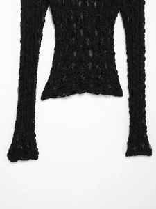 Close-up detail of black popcorn texture lace top showing high elasticity and ribbed hem