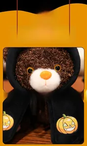 Detail of Halloween teddy bear plush with a black hooded cloak and pumpkin pattern