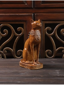 Detail of Egyptian cat Bastet statue with wood-like texture and hieroglyphics on base
