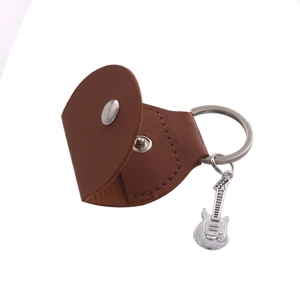Brown leather guitar pick case with a metal snap, key ring, and guitar pendant detail