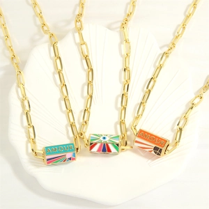 Detailed view of gold paperclip link necklaces with colorful enamel evil eye pendants