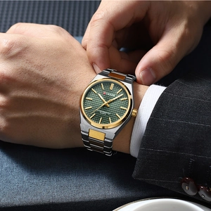 Close-up of CURREN men's quartz watch featuring green dial and silver-gold steel band